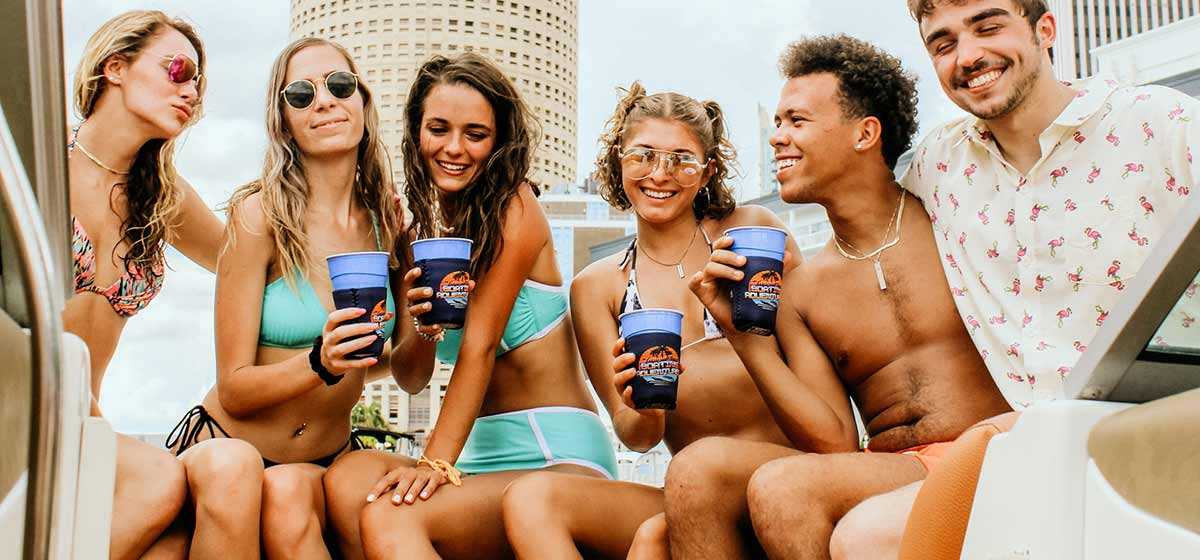 Young friends smiling on a party boat near Downtown Tampa, FL.