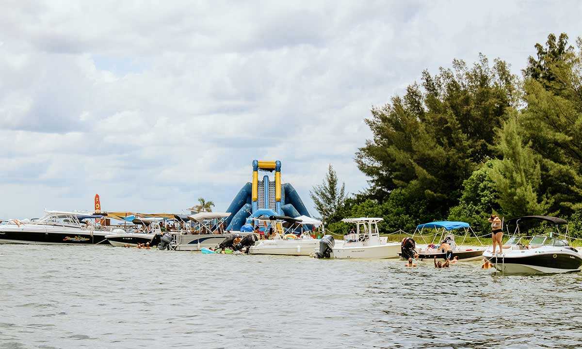Private beach with water slide and boats near Beer Can Island, FL.